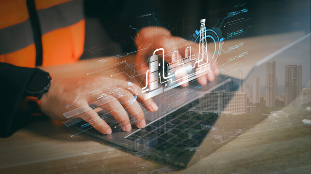 Engineer using laptop with holographic oil refinery plant overlay. Concept of smart factory automation technology, future energy innovation, and industrial digital transformation. - Powered by Adobe