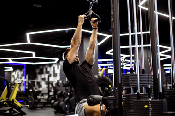 Fitness enthusiast performs workout routine in modern gym with vibrant lighting