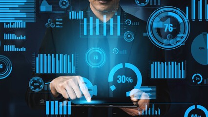 A professional businessman engages in data analysis on a tablet, surrounded by vibrant digital graphs and charts, showcasing insights and trends in a corporate environment. Xenic