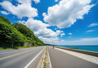 Coastal road with a cyclist and a pink balloon in sky