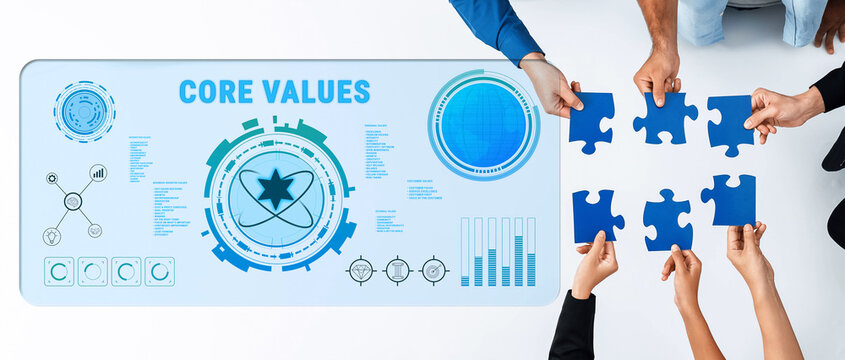 A group of diverse hands collaborates to assemble blue puzzle pieces over a digital core values interface in a modern business setting, symbolizing teamwork and strategy. Trope