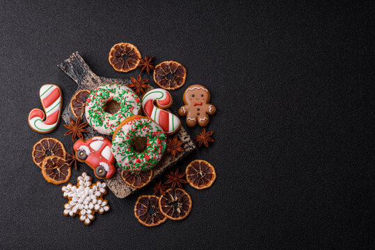 Christmas donuts or doughnuts, holiday winter sweets with sprinkles. Christmas donuts
