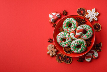 Christmas donuts or doughnuts, holiday winter sweets with sprinkles. Christmas donuts