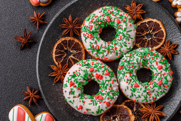 Christmas donuts or doughnuts, holiday winter sweets with sprinkles. Christmas donuts