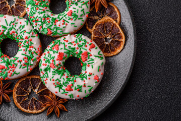 Christmas donuts or doughnuts, holiday winter sweets with sprinkles. Christmas donuts