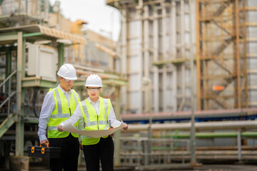 Asian male and female engineers at the nuclear power plant manage advanced machinery to improve safety, increase clean energy output, and support long-term innovation across the global industry.