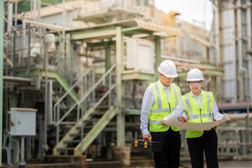 Inside the nuclear power plant, Asian male and female engineers operate high-precision machinery designed to stabilize energy production and support future advancements in the international industry.