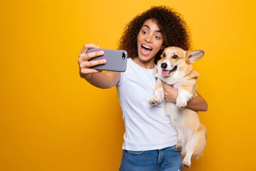 Woman taking selfie with corgi dog pet on yellow background pet photography