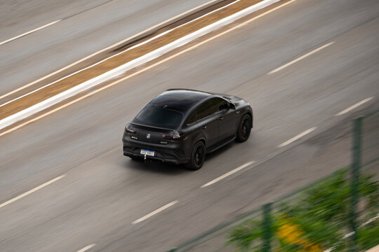 Matte black Mercedes-Benz GLE Coupe driving on highway with motion blur