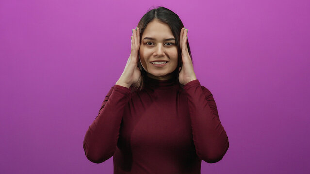 Woman expressing emotions on a vivid pink background wearing a burgundy outfit, demonstrating a range of facial expressions with dynamic hand gestures