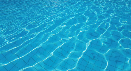 Clear blue water surface with ripples in a swimming pool  