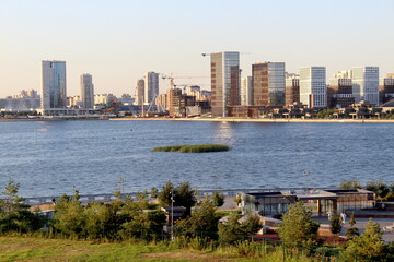 The city is visible from afar on the river bank.	