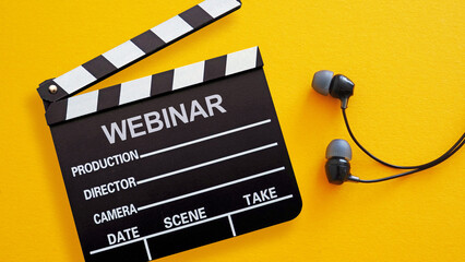 Webinar invitation is shown by a clapperboard with the word WEBINAR and a pair of in-ear headphones on a yellow background