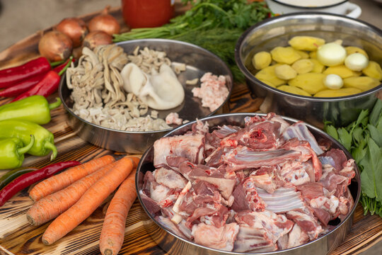 A man cooks traditional lamb soup in a cauldron over an outdoor fire in the Gagauzia autonomous region of Moldova. 