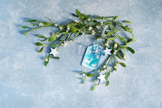 DIY Christmas greeting paper card with deers, decorative stars, mistletoe branches on blue-gray background. decor for Christmas, Advent, Yule, New year holidays, festive winter season. top view