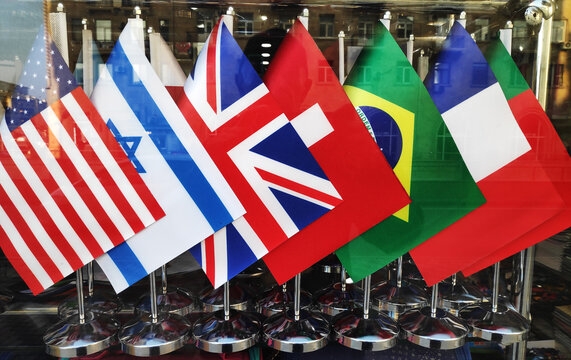 Flags of European countries and the flag of the European Union , America, England, France on the table.