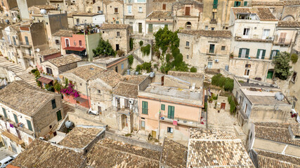 Aerial view of the roofs, houses and apartments, ideal for the concept of an Italian hilltop village nestled among the mountains. It's the historic center of Modica, province of Ragusa, Sicily, Italy.