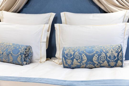 Luxurious blue and white bedroom scene featuring a canopy-inspired headboard