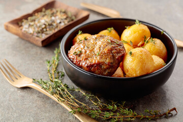 Roasted potatoes with cutlet and thyme.