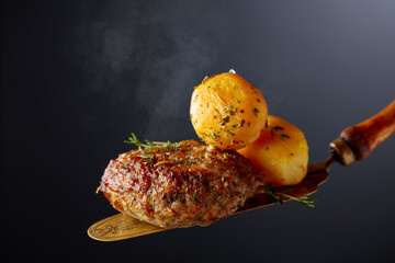 Roasted potatoes with cutlet and thyme.