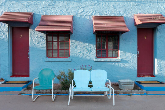 Tucumcari, New Mexico, USA. Famous Blue Swallow Motel room exterior with old metal chairs.  Property released 