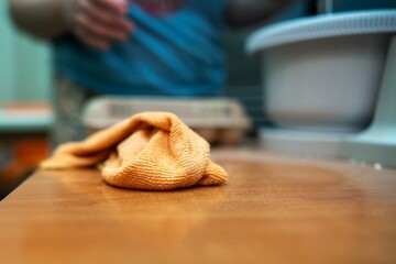 Microfiber cloth lying on kitchen table after wiping flour during baking cleanup