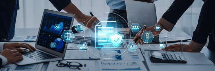 Professionals work together in a modern office setting, utilizing technology and data analytics to...