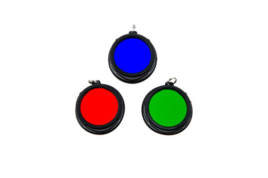 Three round colored filters (red, green, blue) for a tactical flashlight on a white back