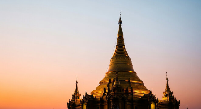 golden pagoda silhouette glowing against soft sky gradient, spiritual theme