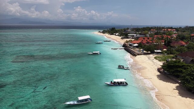 Beautiful sea coastline with waves of Bali, Nusa Lembongan Suka beach Island drone aerial shot in Indonesia surrounded by beautiful jungle and tropical blue sea water and cliffs