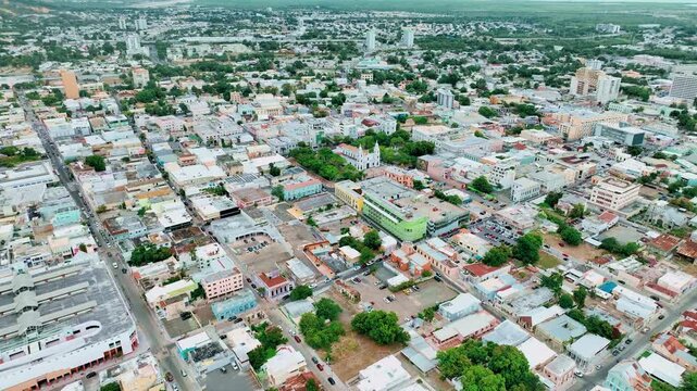 Aerial drone footage of Ponce, Puerto Rico, showcasing the city&rsquo;s colorful colonial architecture, central plazas and coastal landscape from above. Smooth flight movement and clear Caribbean light high