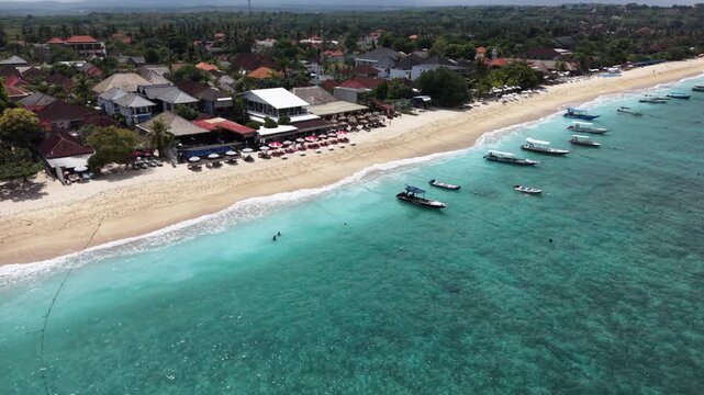 Beautiful sea coastline with waves of Bali, Nusa Lembongan Suka beach Island drone aerial shot in Indonesia surrounded by beautiful jungle and tropical blue sea water and cliffs