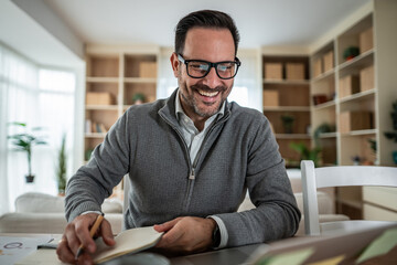 Happy man working remotely from home discussing video call