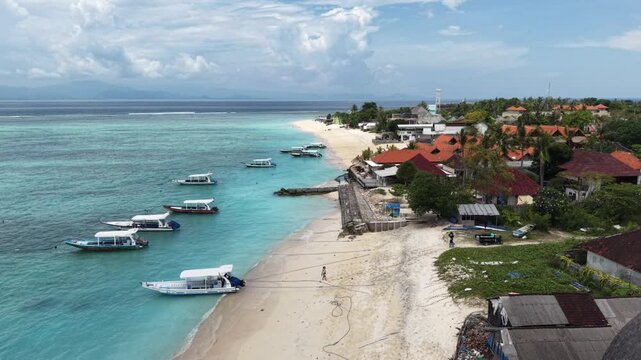 Beautiful sea coastline with waves of Bali, Nusa Lembongan Suka beach Island drone aerial shot in Indonesia surrounded by beautiful jungle and tropical blue sea water and cliffs