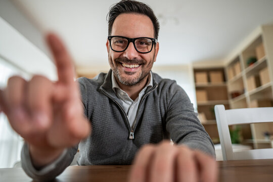 Happy man having video call and touching screen