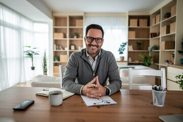 Business man smiling during remote work from home office