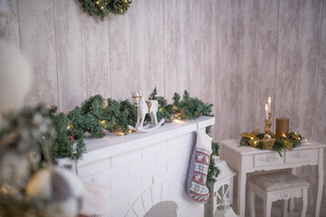 Festively decorated white mantel with evergreen garland, a vintage rocking horse, and candles, creating a cozy holiday atmosphere with seasonal charm and warmth