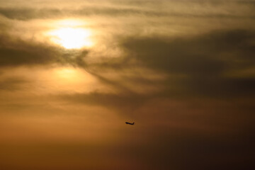 Airplane Silhouette Against Sunset Sky