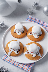 Gingerbread cookie with melting snowman topping on a white background