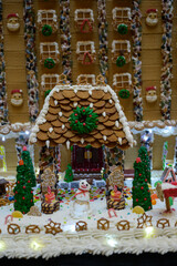 christmas gingerbread house decoration with snowman candy and white icing like snow