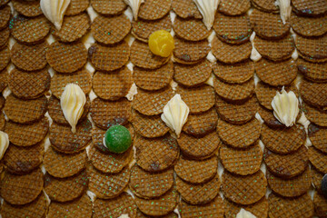 christmas gingerbread house decoration with cookies, candy and white icing like snow