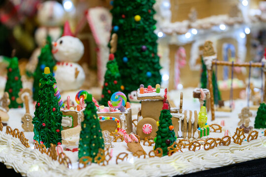 christmas gingerbread house decoration with snowman candy and white icing like snow - Powered by Adobe