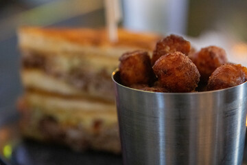 A Cheesy sandwich and hushpuppies
