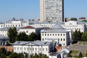 View of a city with houses and trees on a sunny hot summer day.	