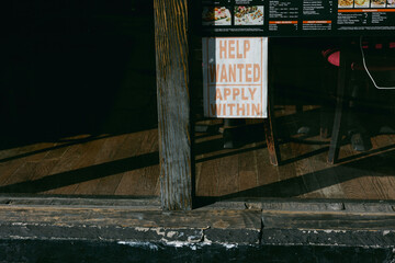 Help wanted sign displayed in restaurant window during afternoon hours