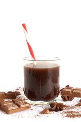 On a white background there is a glass cup of cocoa with a straw.