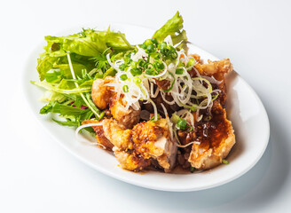 karaage chicken with crisp salad and scallions. Ideal for restaurant menus, food blogs, or social media. Fresh, delicious, and visually appealing.
