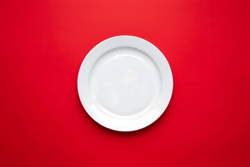 White plate on red background top view food photography flat lay style