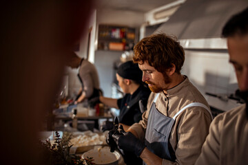 Adult male chef focused on prep work in restaurant kitchen