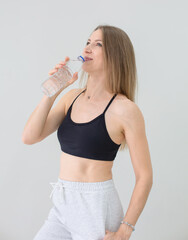 Fit Woman in Athletic Wear Holding Water Bottle After Workout